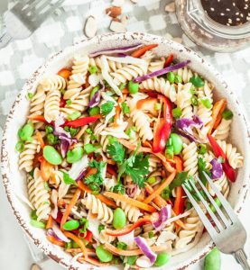 Asian pasta salad made with Jimmy's Cole Slaw Dressing, red pepper, peanut butter, pea pods, ginger and garlic