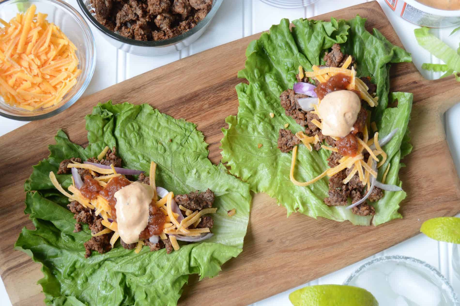 Lettuce wraps make with ground beef, cheese, red onion, Jimmy's Pineapple Salsa and Jimmy's Taco Dip